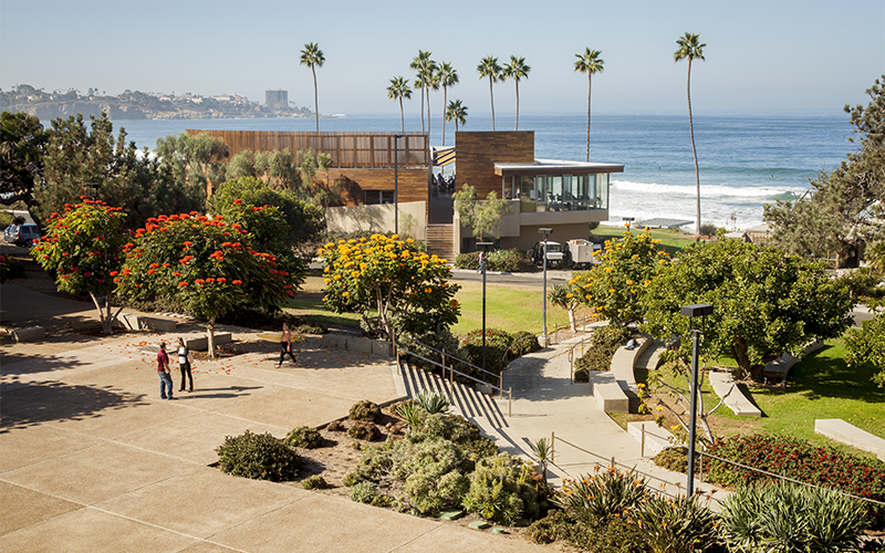 An image of a modern building and university campus near the ocean.
